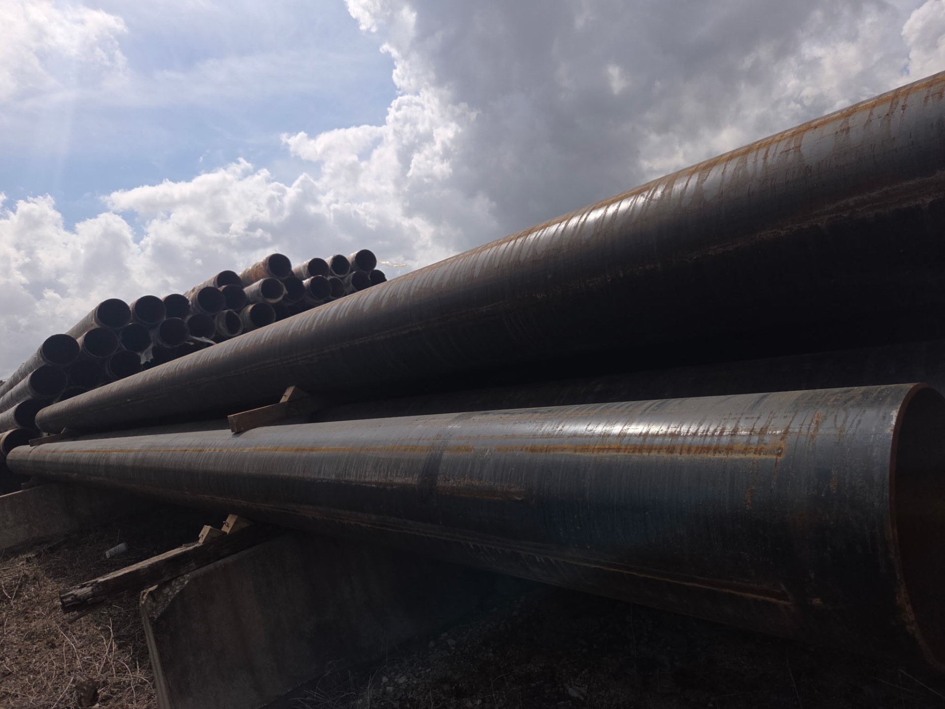 Stacked carbon steel pipe at distribution yard